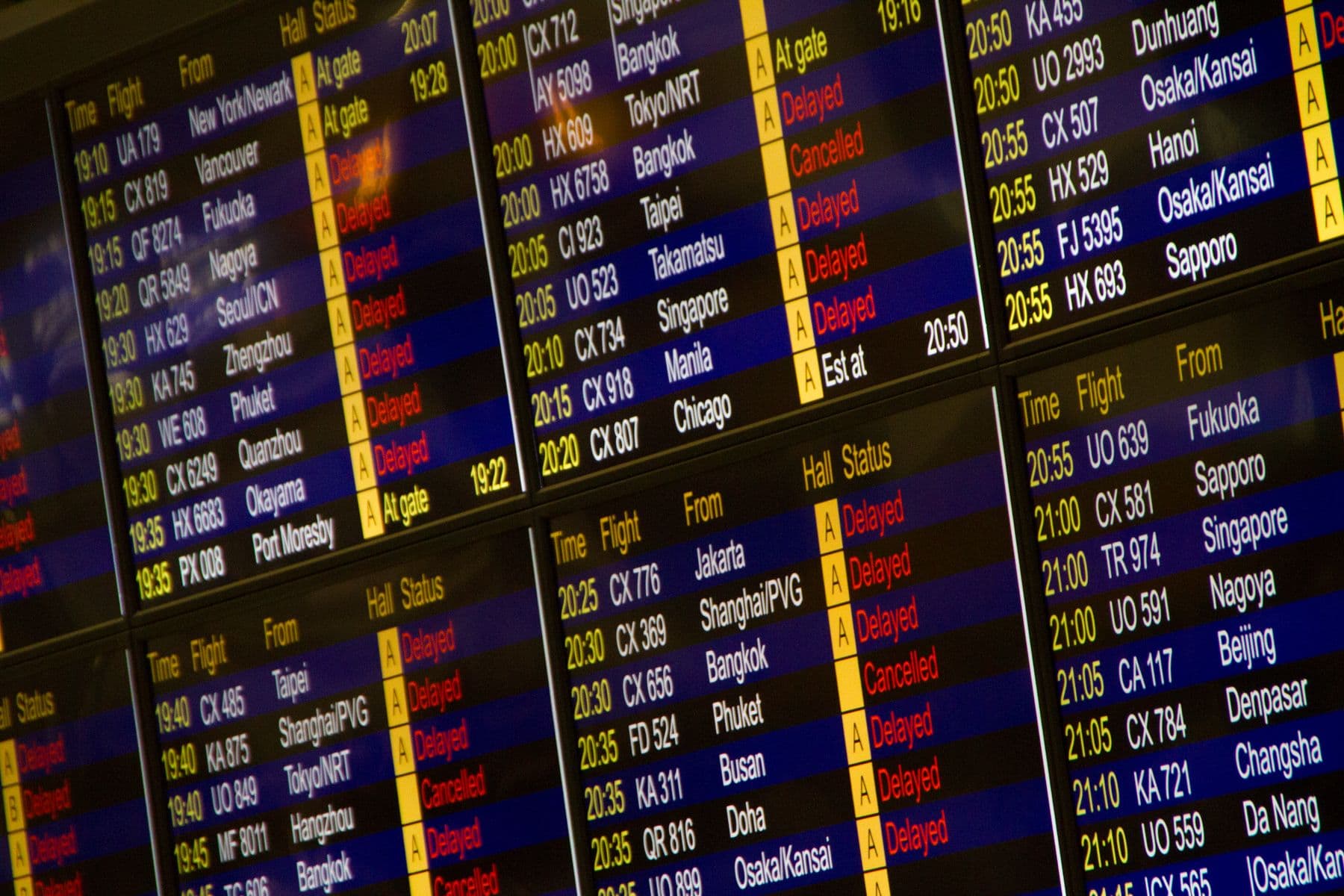 Airport flight information board showing departures and status changes