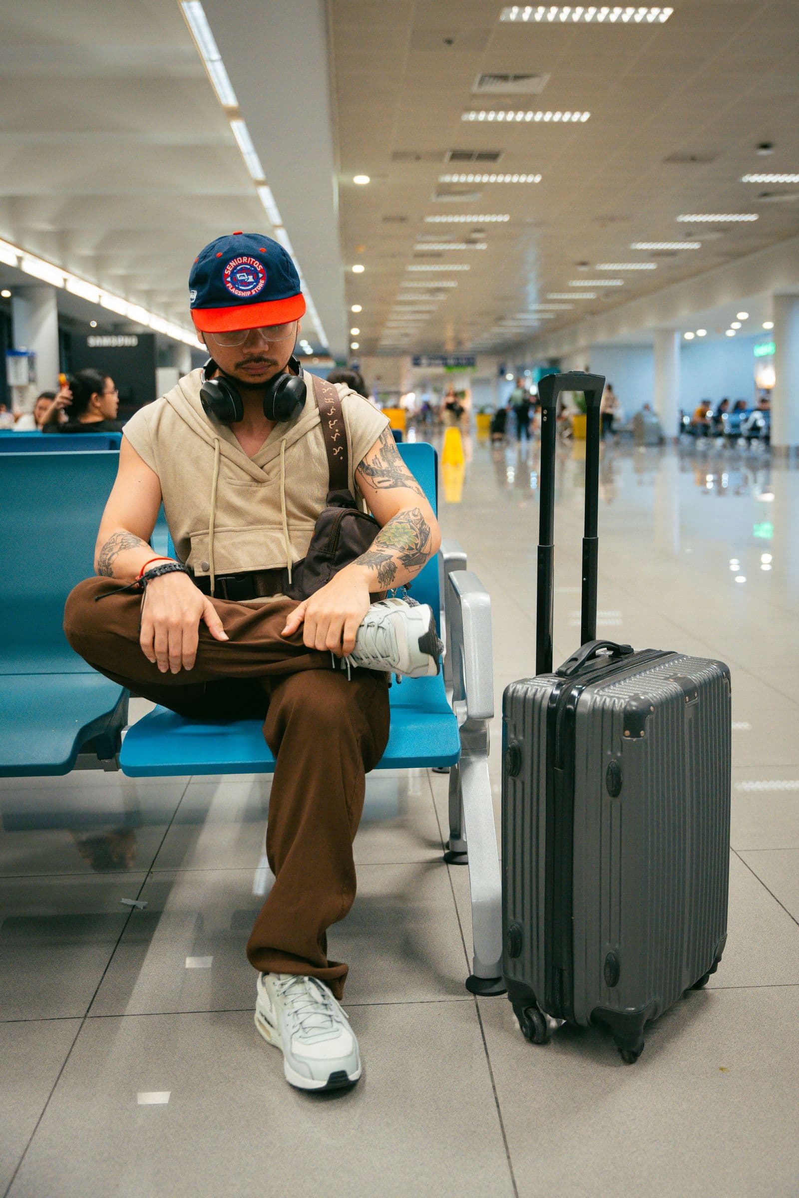 Traveler waiting with luggage in an airport lounge