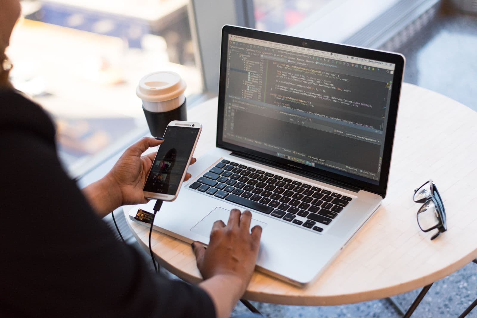 Person researching on a laptop and phone