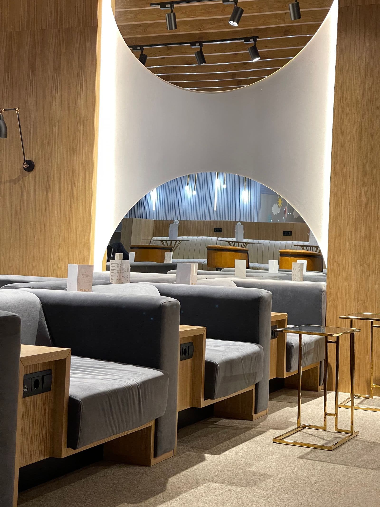 Upholstered seating and side tables in an airport lounge at Ufa