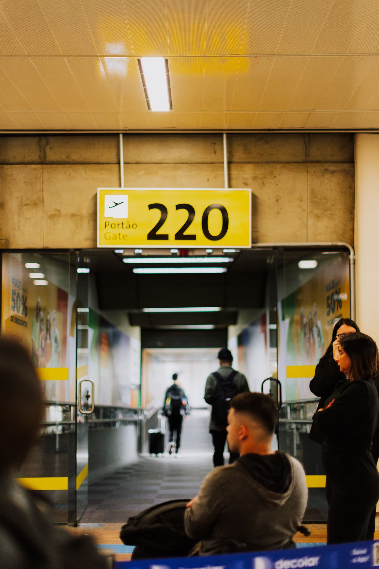 Travelers waiting near an airport boarding gate