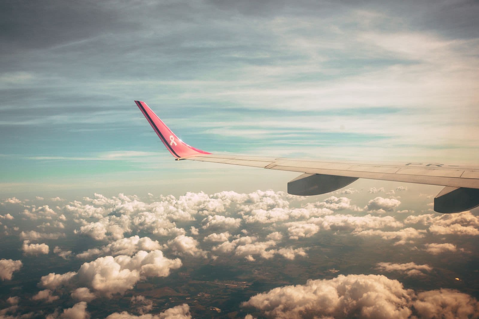Airplane wing photographed in a clear morning sky