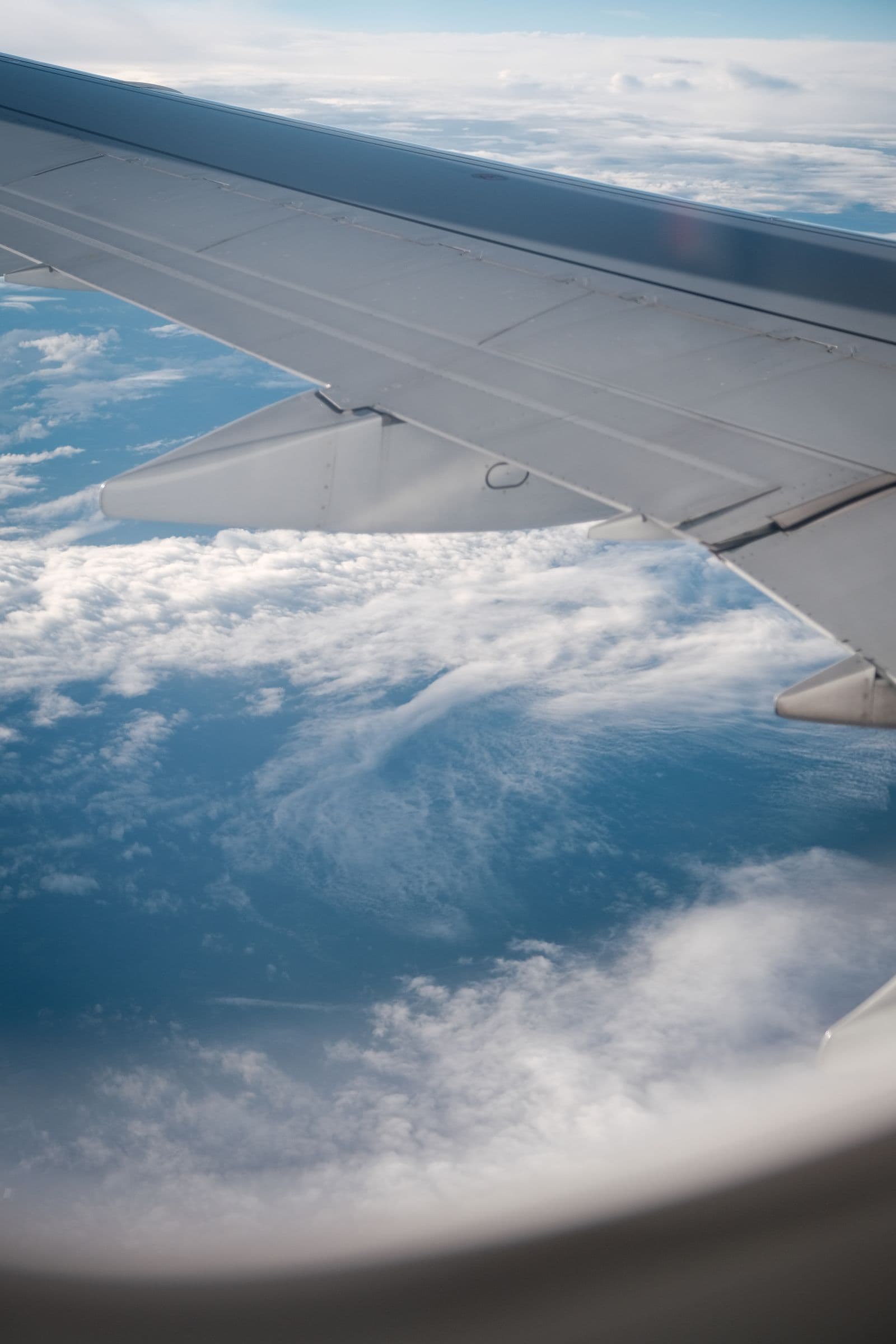 Passenger window view of an airplane wing in flight