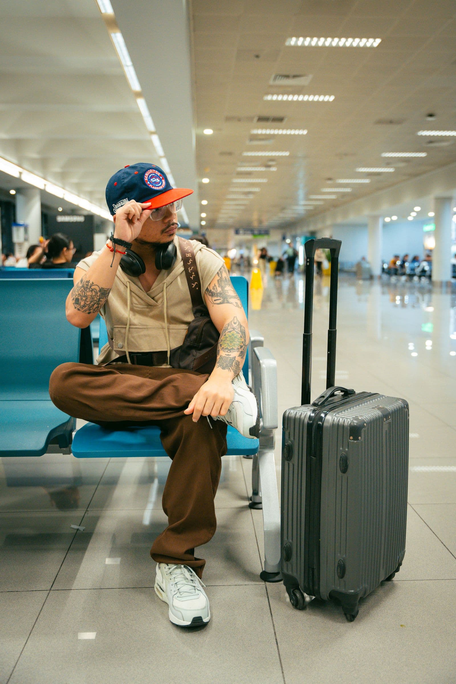 Traveler waiting with luggage in an airport terminal