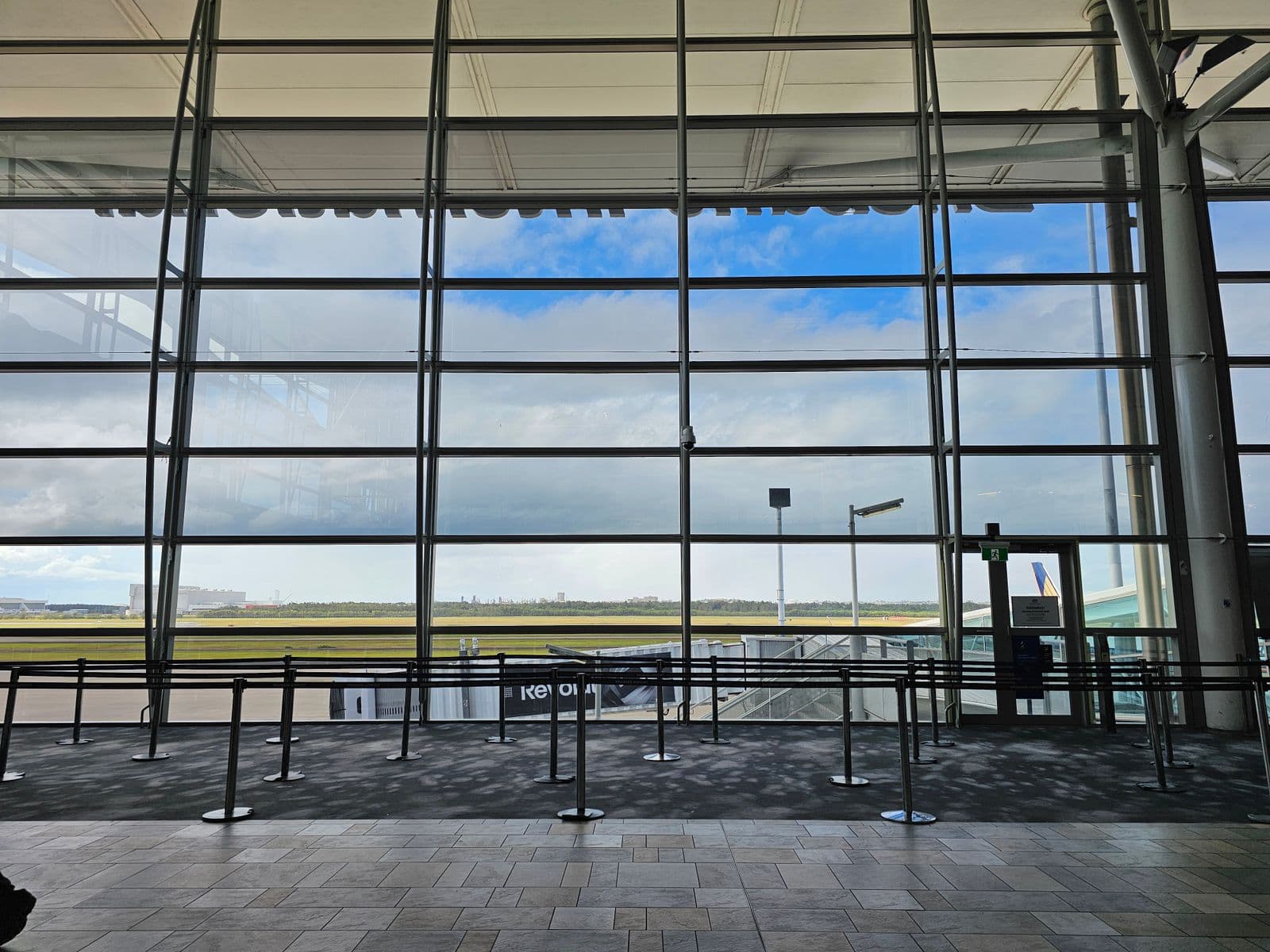 Spacious airport terminal with a panoramic view of the runway