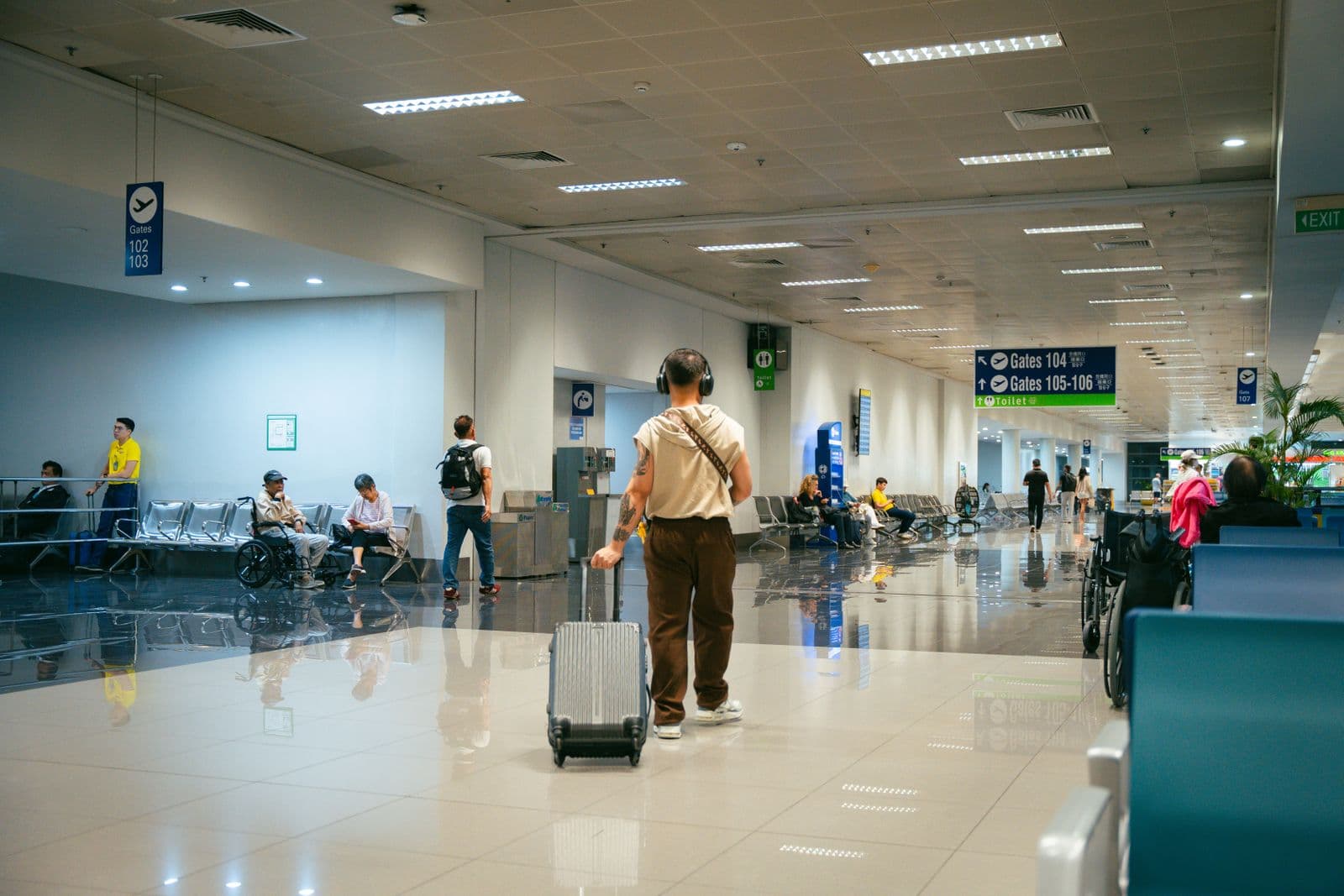 Modern airport terminal with passengers and gate seating