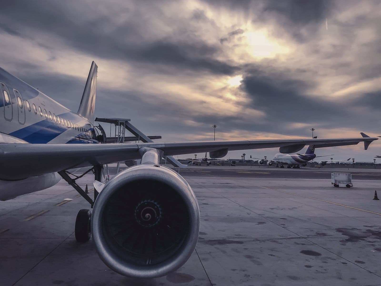 Unbranded commercial aircraft on an airport apron at sunset