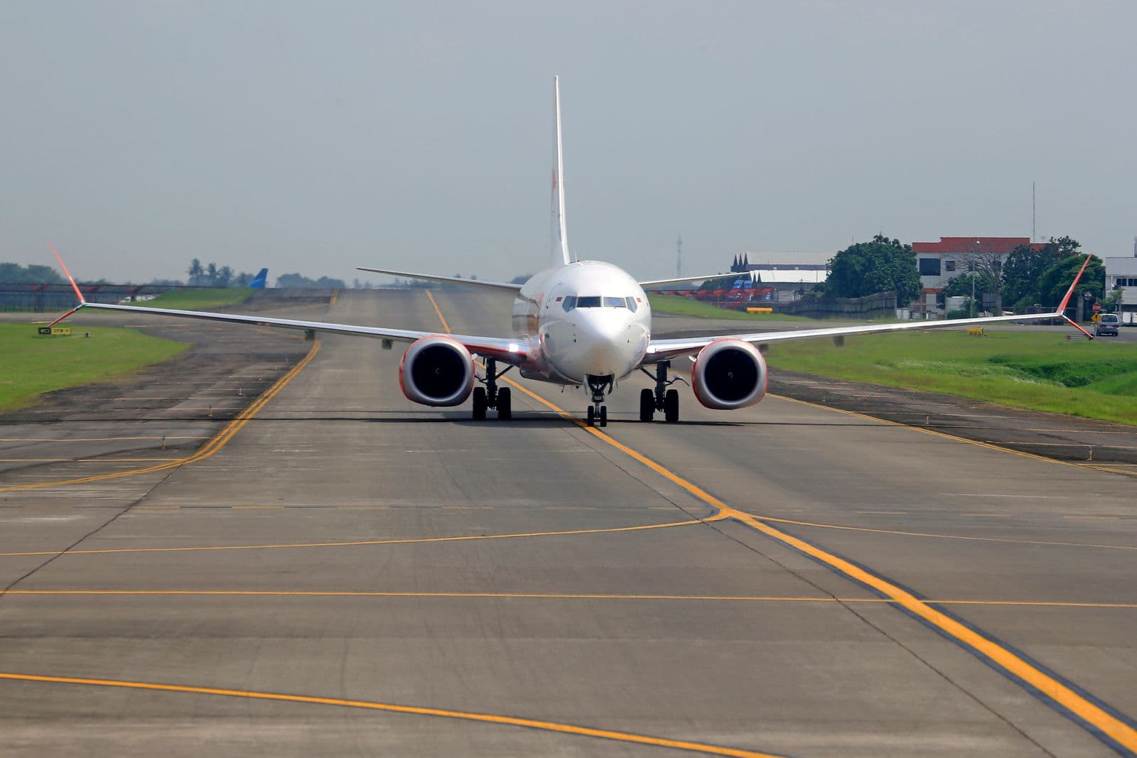 Commercial aircraft taxiing on an airport runway