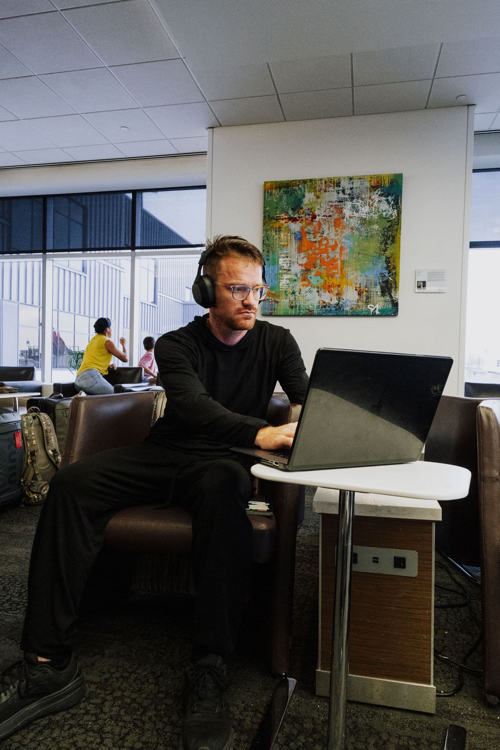 Traveler comparing travel figures on a laptop in an airport lounge