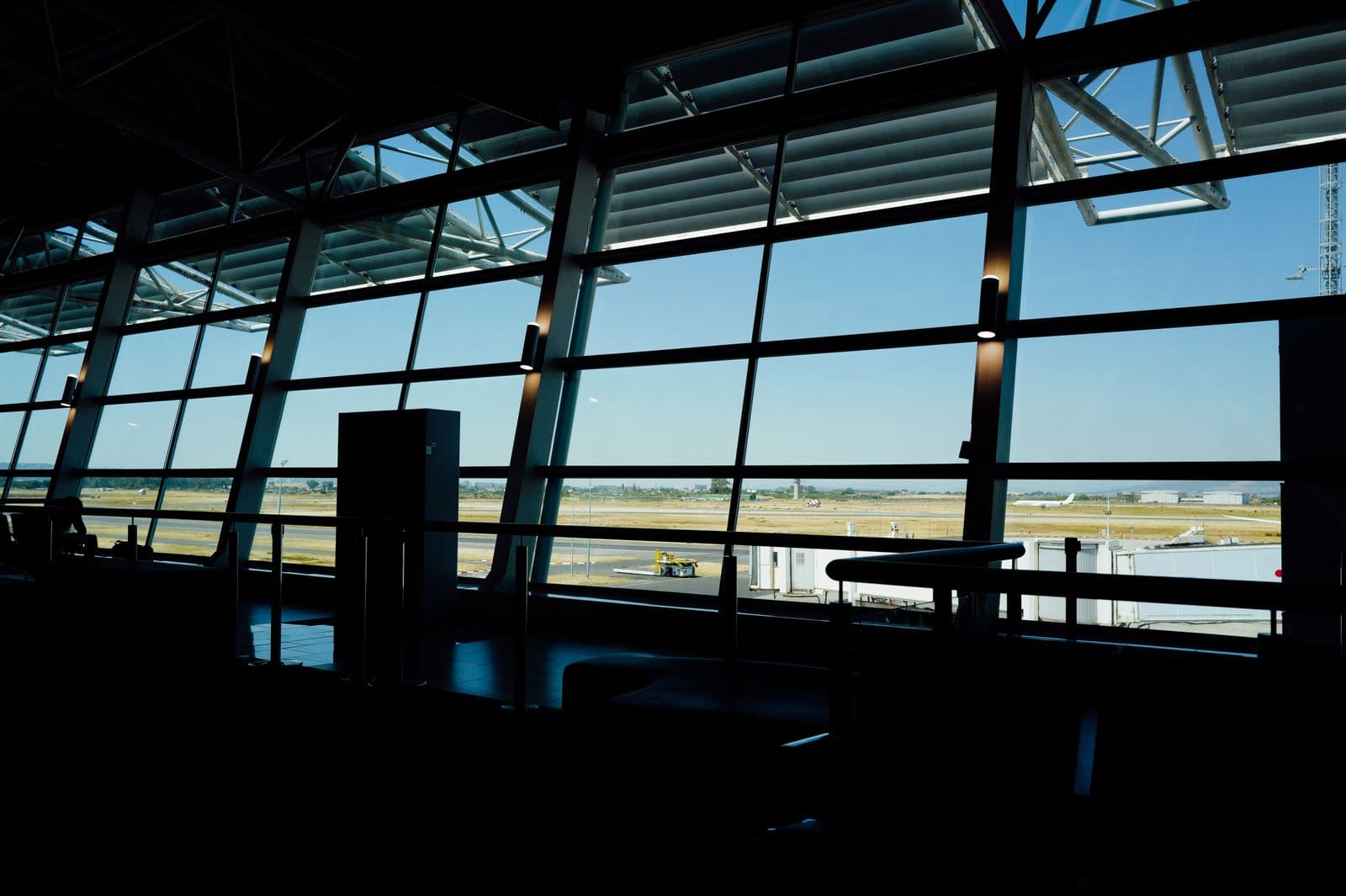 Modern airport terminal overlooking an empty runway