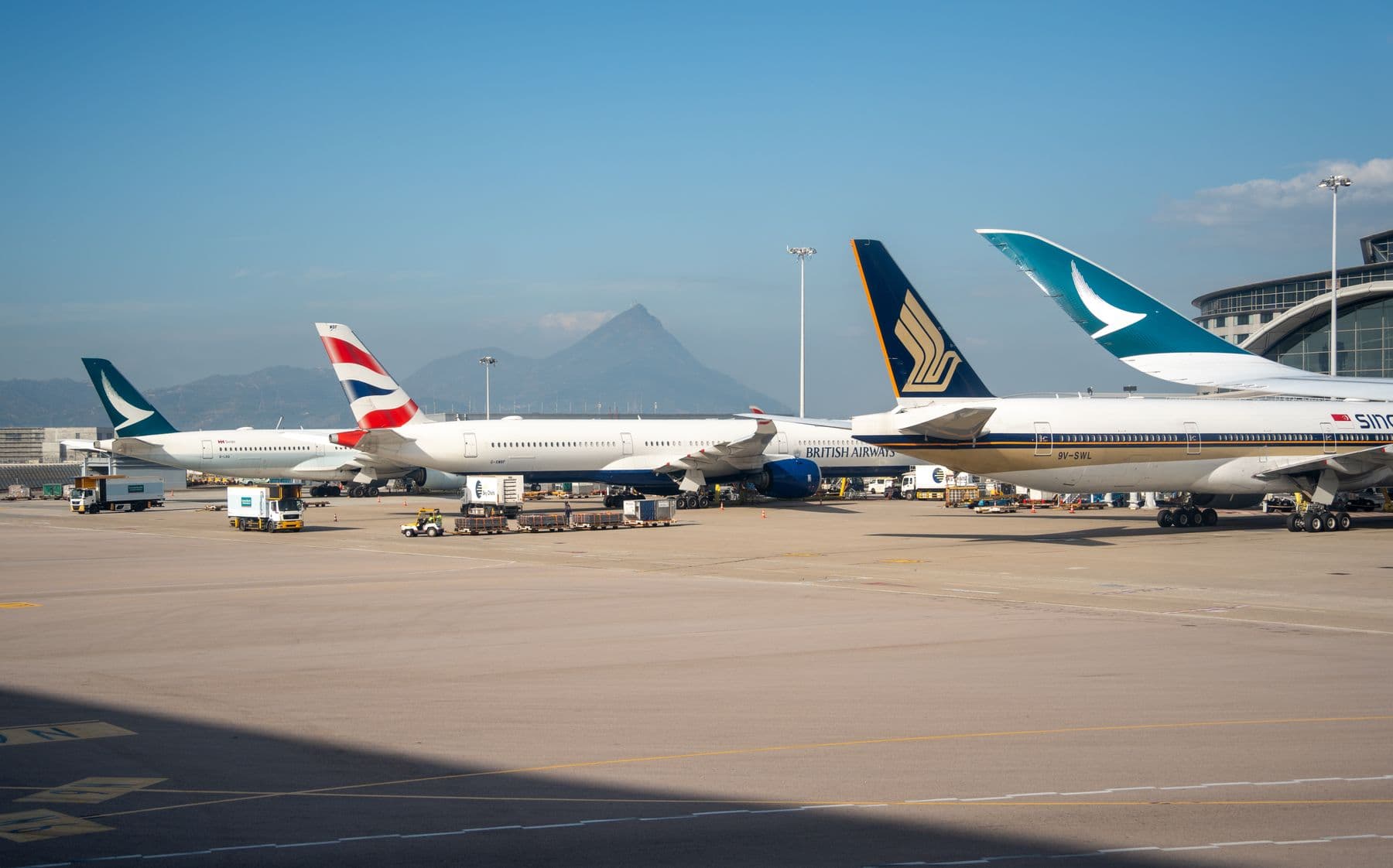 Cathay Pacific, British Airways, and Singapore Airlines aircraft parked at Hong Kong airport